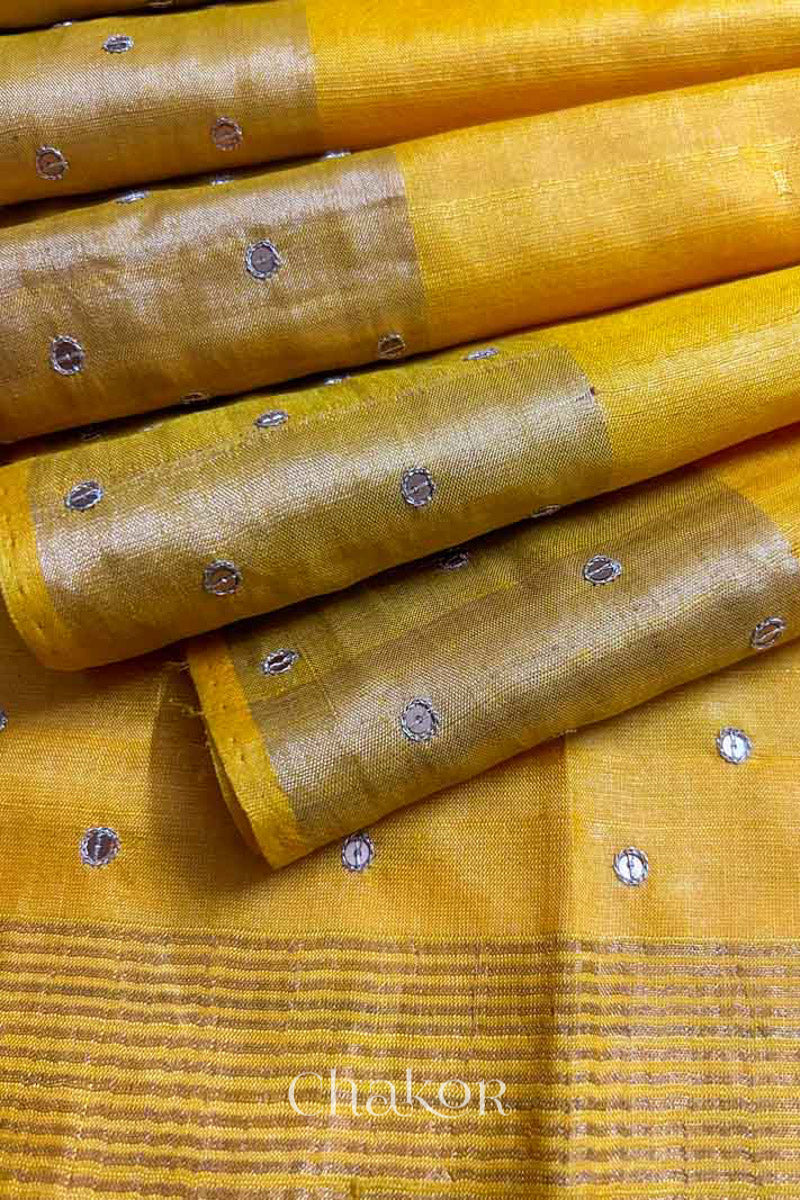 Close up of Yellow tussar silk handloom saree with golden zari border & hand embroidered with  sequins & zari work