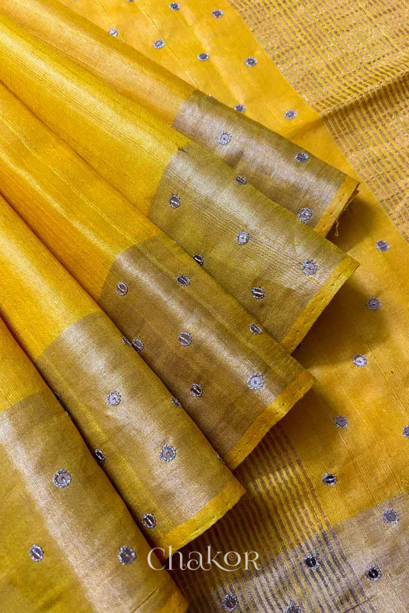 Close up of Yellow tussar silk handloom saree with golden zari border & hand embroidered with  sequins & zari work