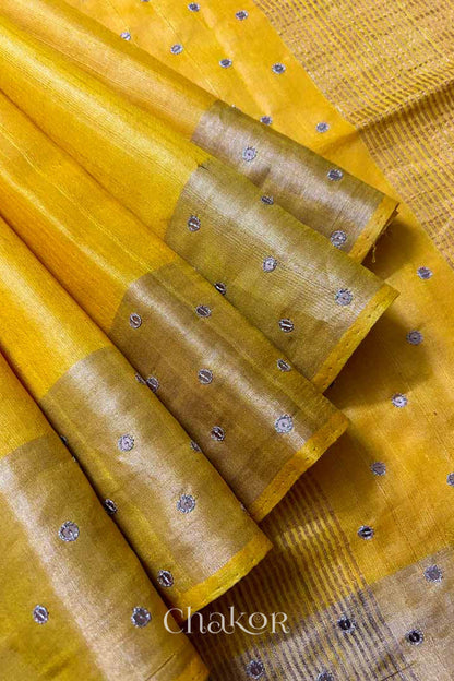 Close up of Yellow tussar silk handloom saree with golden zari border & hand embroidered with  sequins & zari work