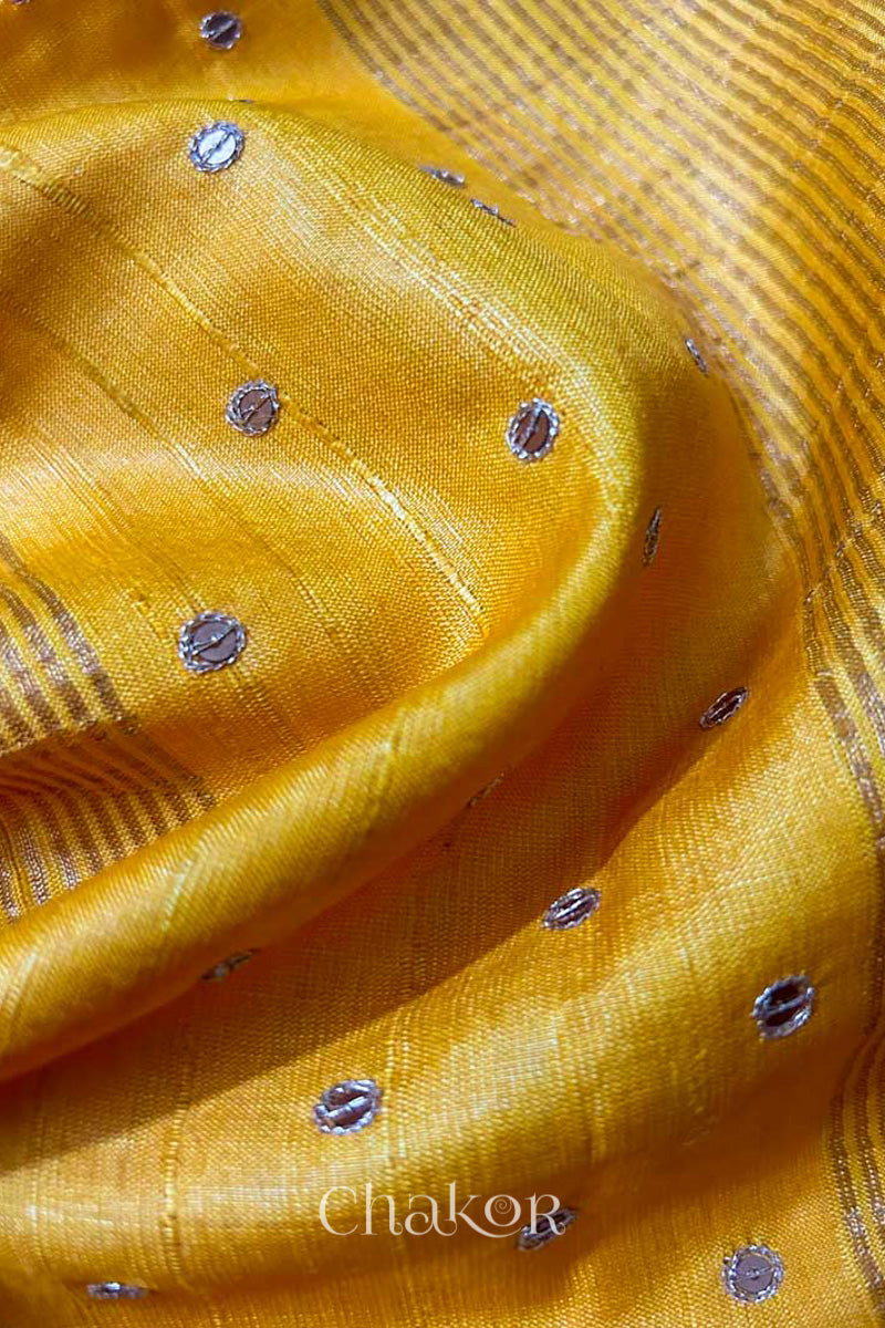 Close up of Yellow tussar silk handloom saree with golden zari border & hand embroidered with  sequins & zari work