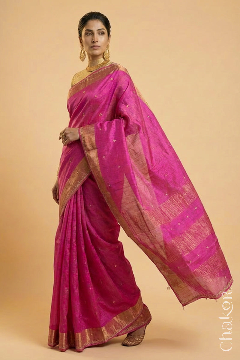 Woman wearing a Pink tussar silk handloom saree with golden zari border & hand embroidered with  sequins & zari work
