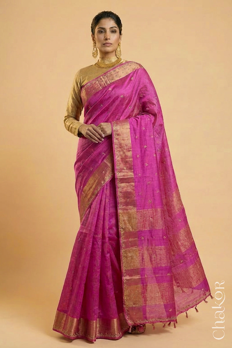 Woman wearing a Pink tussar silk handloom saree with golden zari border & hand embroidered with  sequins & zari work