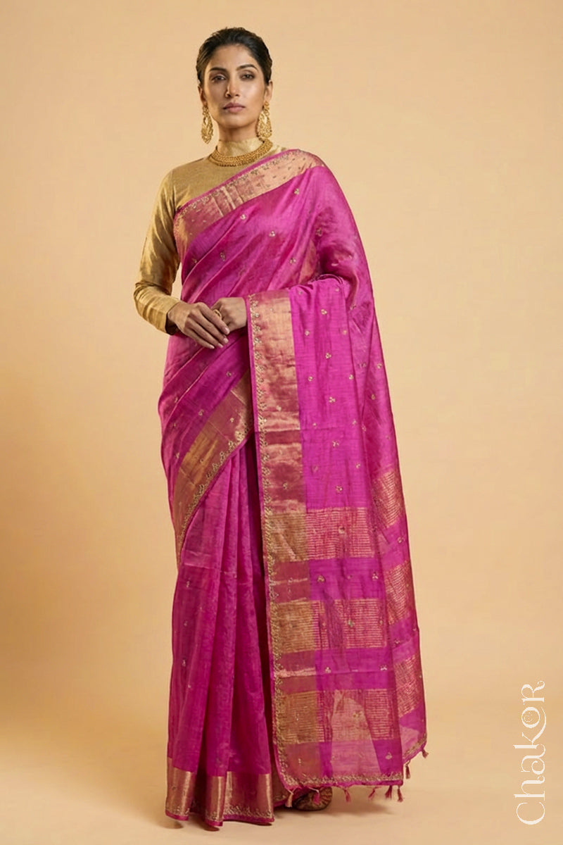 Woman wearing a Pink tussar silk handloom saree with golden zari border & hand embroidered with  sequins & zari work