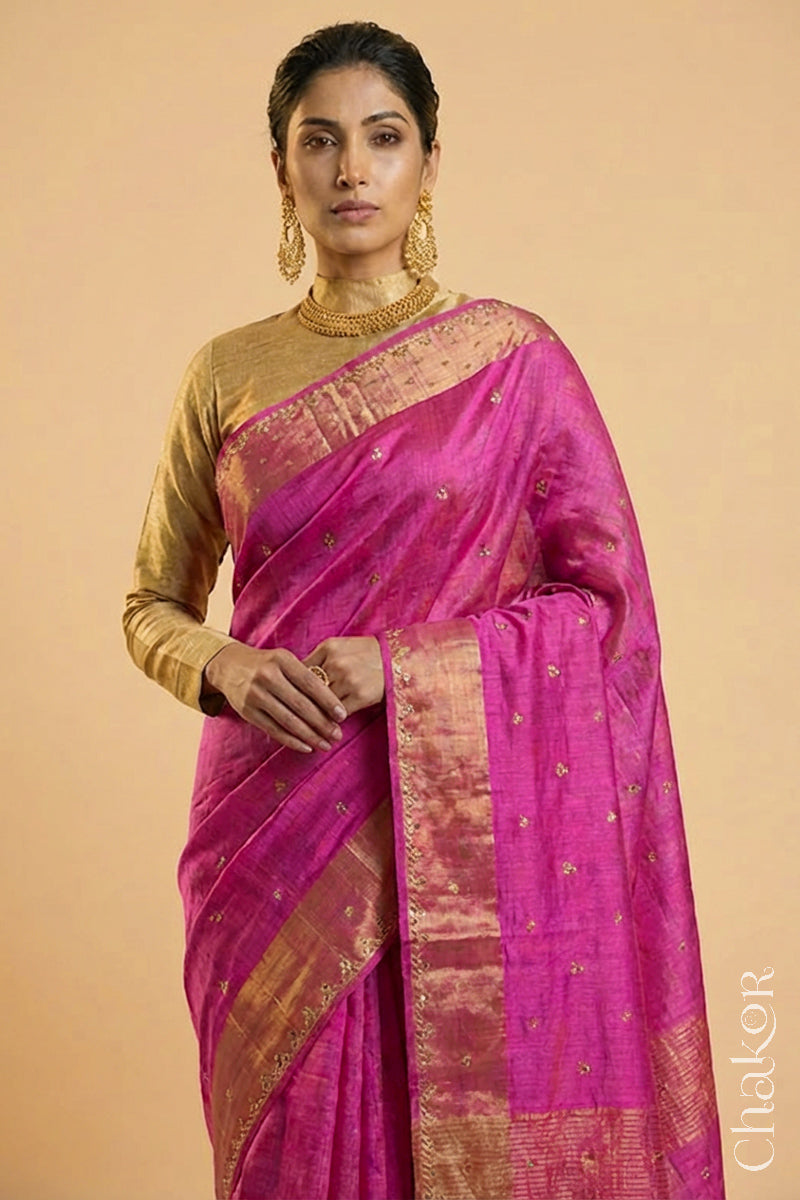 Woman wearing a Pink tussar silk handloom saree with golden zari border & hand embroidered with  sequins & zari work
