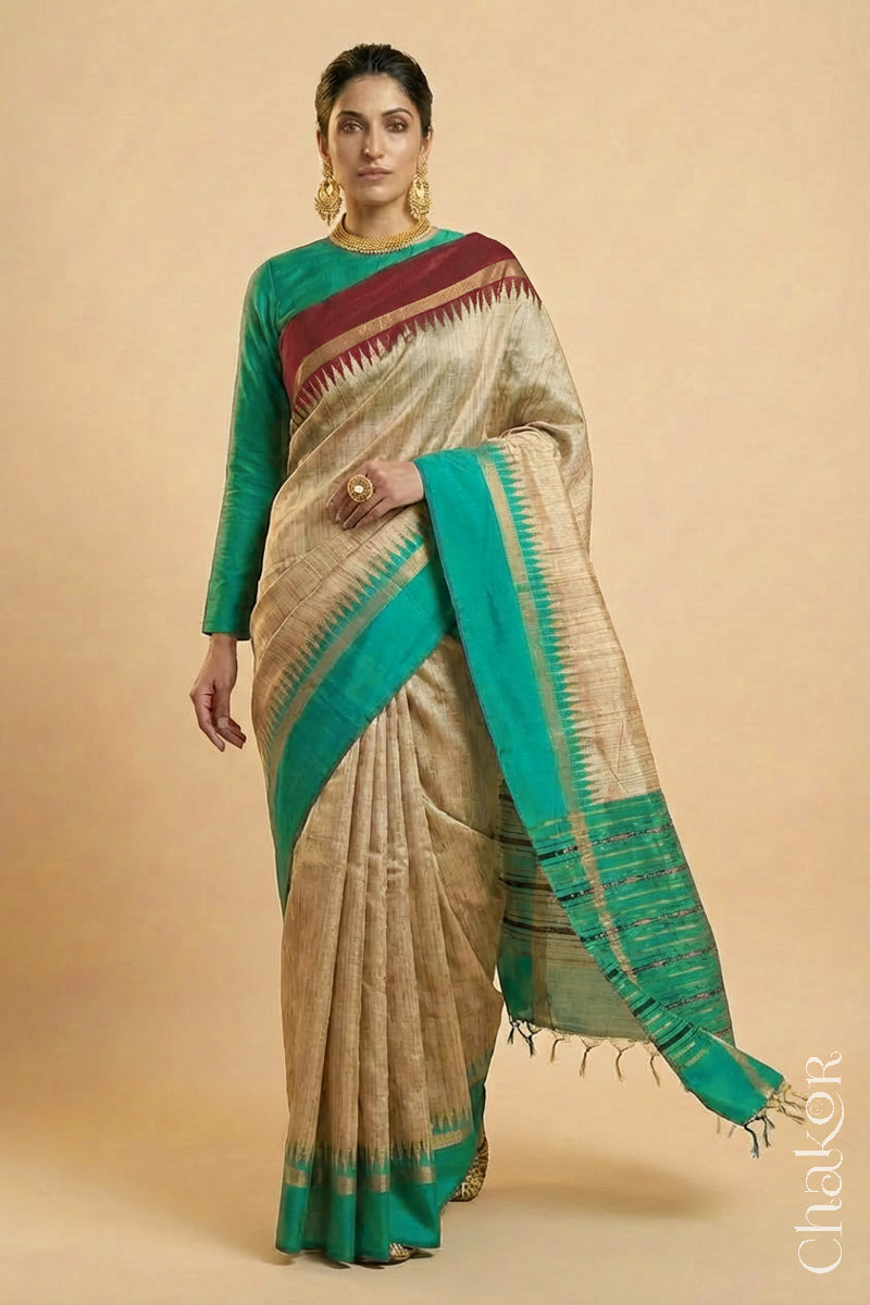 Woman wearing a traditional Jade Green and Natural tussar silk handloom temple border saree