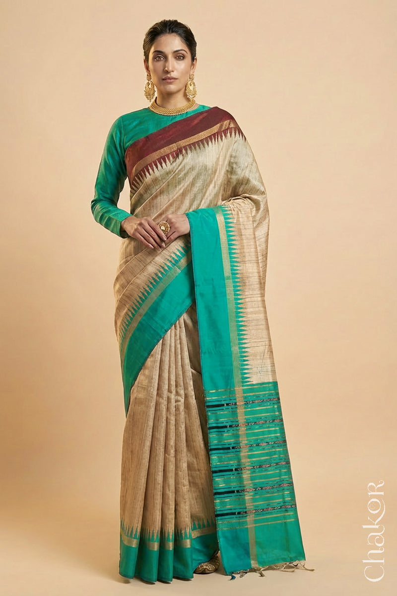 Woman wearing a traditional Jade Green and Natural tussar silk handloom temple border saree