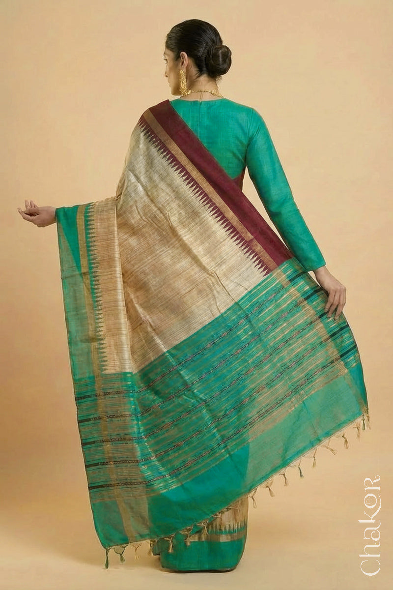 Back pose of Woman wearing a traditional Jade Green and Natural tussar silk handloom temple border saree