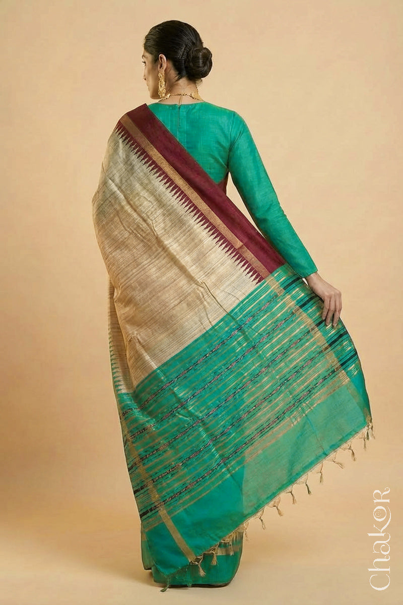 Back pose of Woman wearing a traditional Jade Green and Natural tussar silk handloom temple border saree