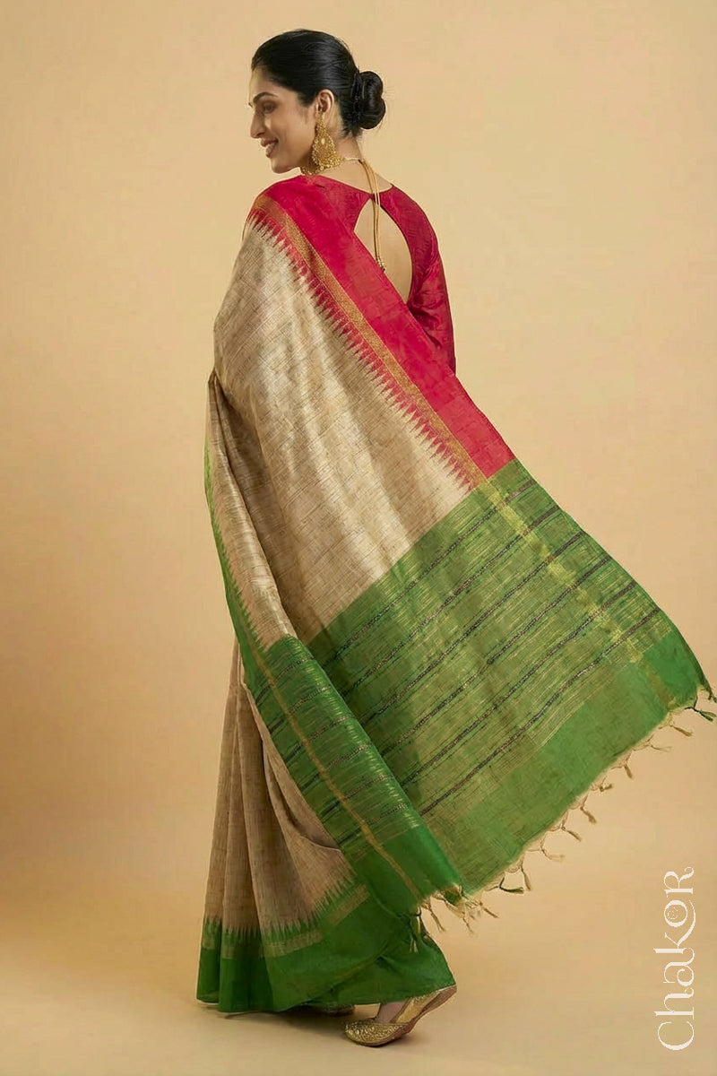 Woman wearing a traditional Green and Natural tussar silk handloom saree