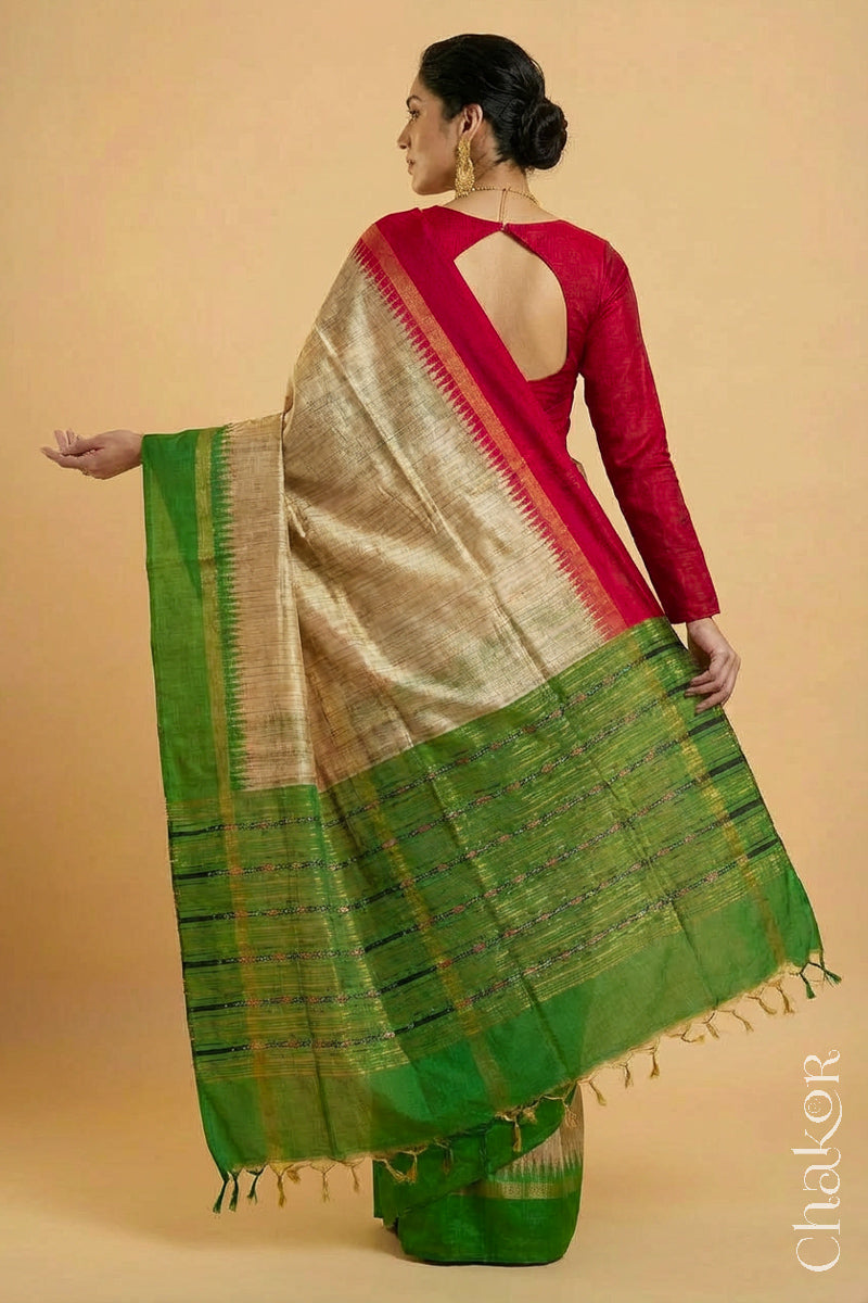 Back pose of a Woman wearing a traditional Green and Natural tussar silk handloom saree