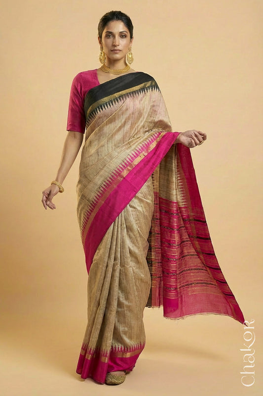 Woman wearing a traditional pink and Natural tussar silk handloom temple border saree