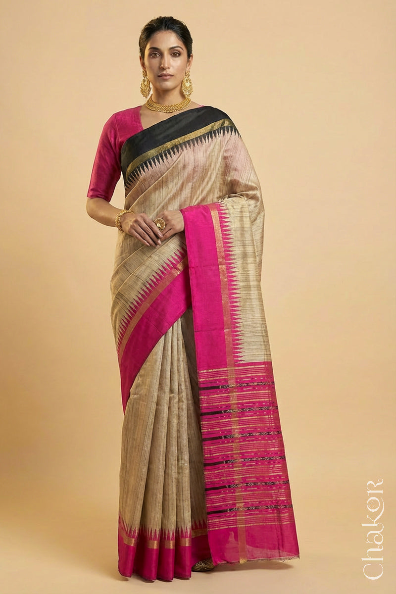 Woman wearing a traditional pink and Natural tussar silk handloom temple border saree