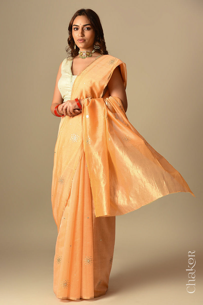 Model wearing Peach Chanderi Silk Cotton Handloom Saree with sequins and mirror embroidery.