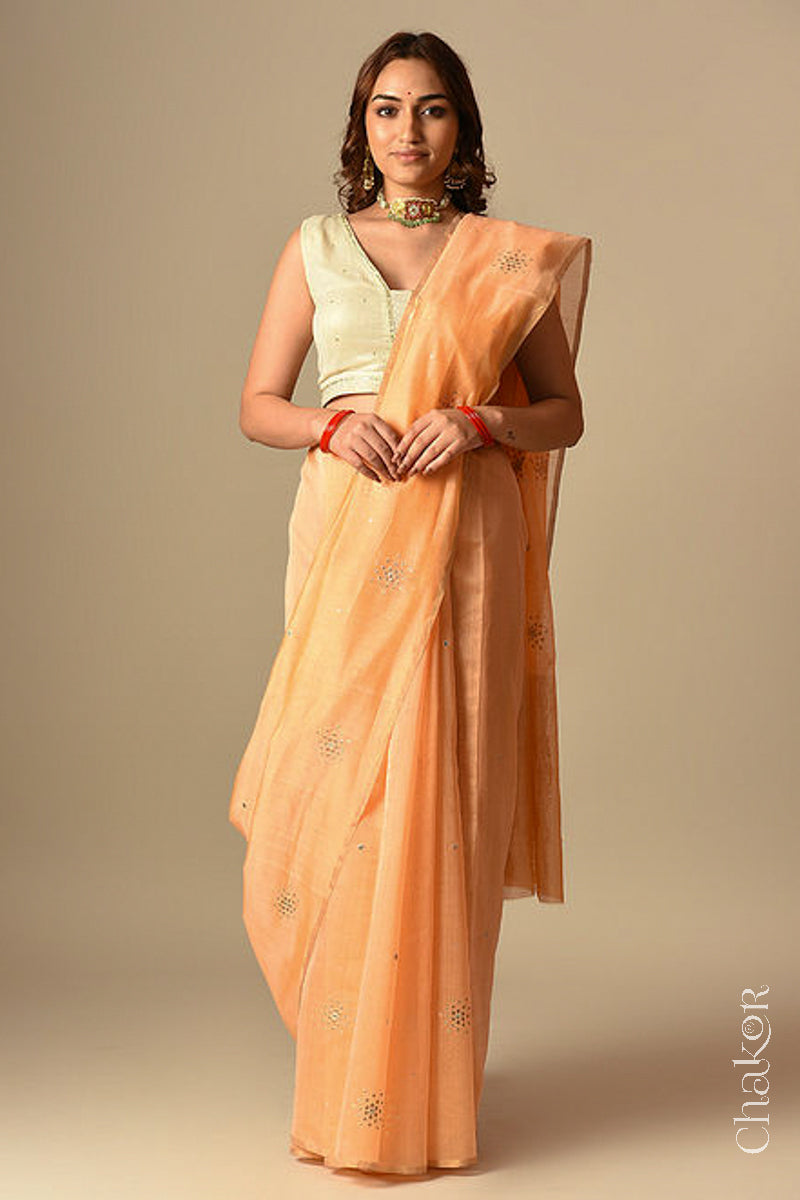 Model wearing Peach Chanderi Silk Cotton Handloom Saree with sequins and mirror embroidery.