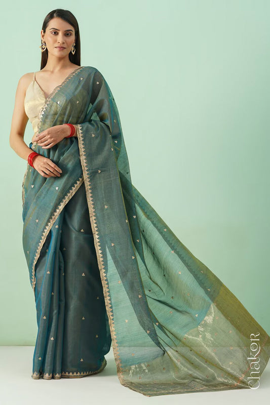 Model wearing a Teal Blue Chanderi  silk cotton saree with hand-embroidered sequin and zari details.
