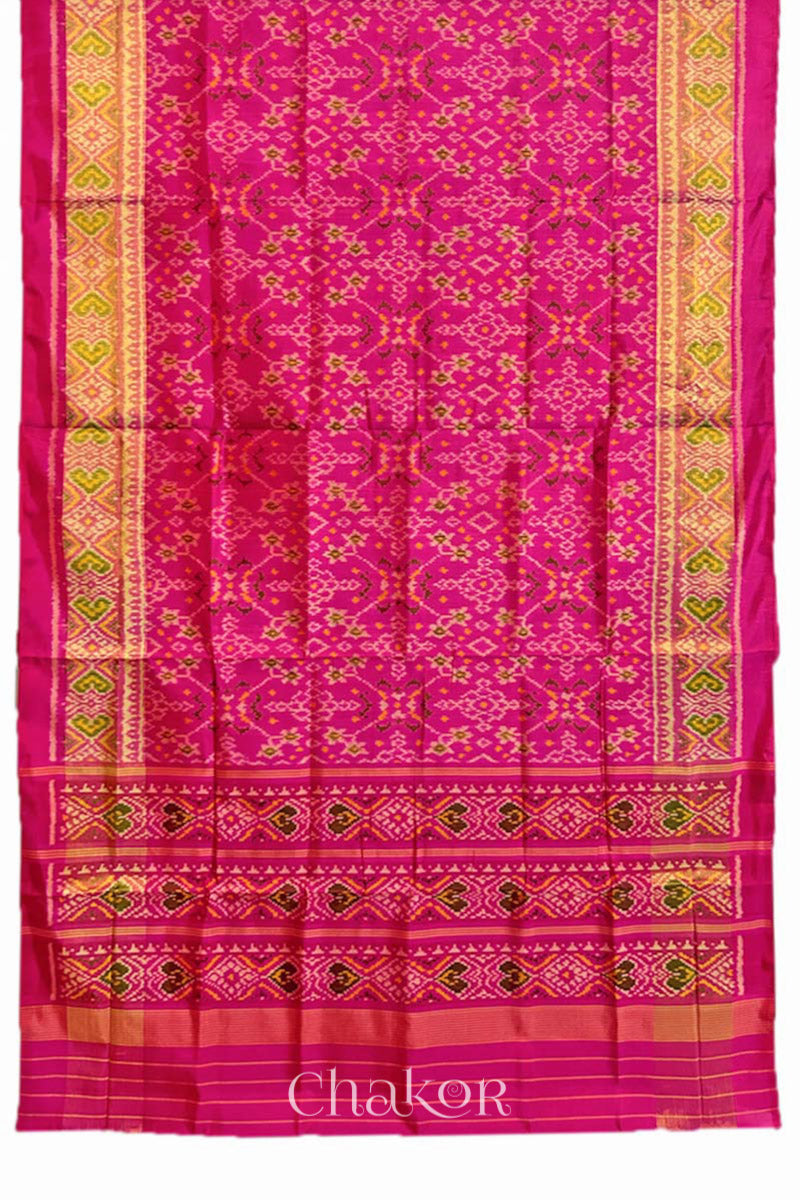 Full view of Handloom Rani Pink Rajkoti Patola Ikat Mulberry Silk Saree with tissue borders, and mauve pallu woven using traditional designs in Gujarat.