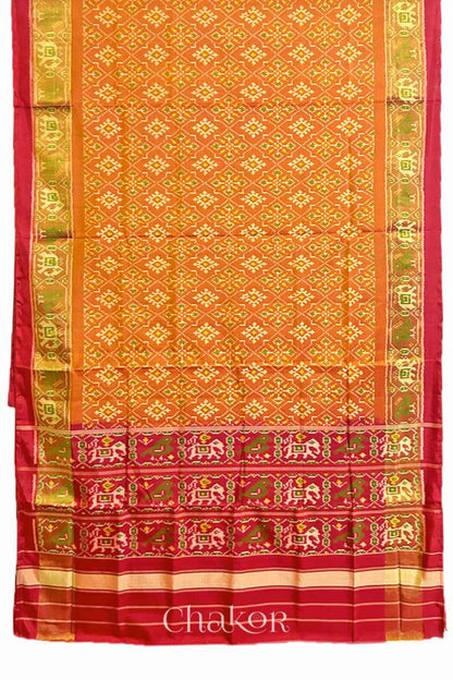 Full view of of Handloom Rust Rajkoti Patola Ikat Mulberry Silk Saree with Red borders & pallu, woven using traditional designs in Gujarat.