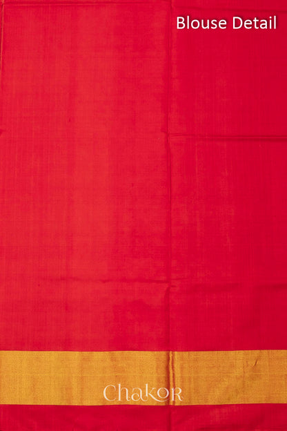 Blouse material detail of Handloom Rust Rajkoti Patola Ikat Mulberry Silk Saree with Red borders & pallu, woven using traditional designs in Gujarat.