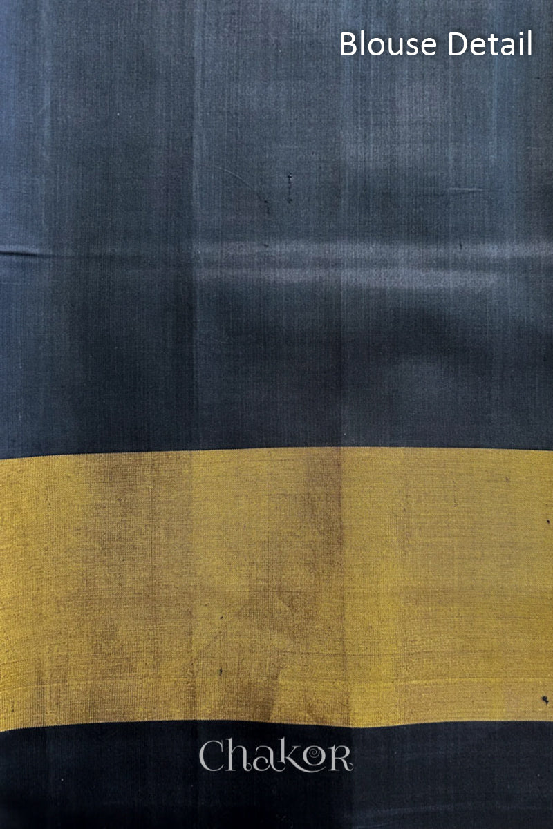 Blouse fabric detail of Handloom Black Patola Ikkat Mulberry Silk Saree with traditional patterns in red floral motifs.