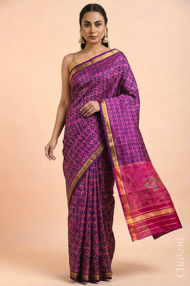 Model wearing Handloom Purple Pink Patola Mulberry Silk Saree in traditional patterns.