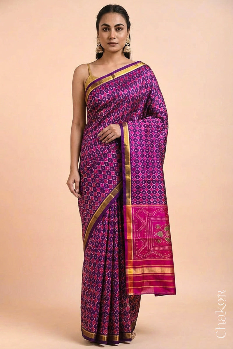 Model wearing Handloom Purple Pink Patola Ikkat Mulberry Silk Saree in traditional patterns.