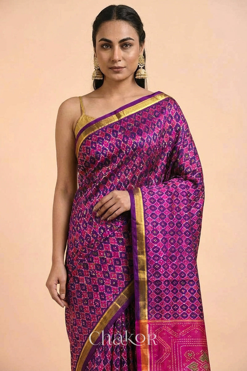 Model wearing Handloom Purple Pink Patola Mulberry Silk Saree in traditional patterns.