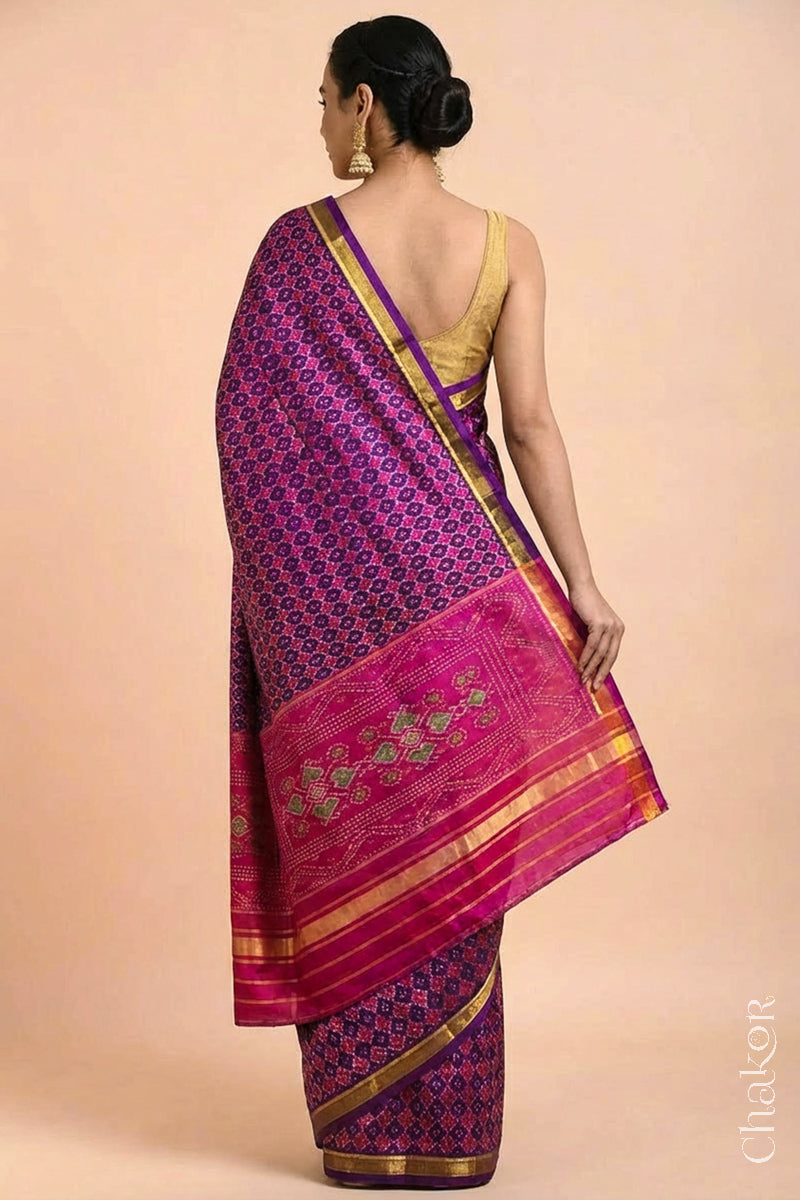 Model wearing Handloom Purple Pink Patola Ikkat Mulberry Silk Saree in traditional patterns.
