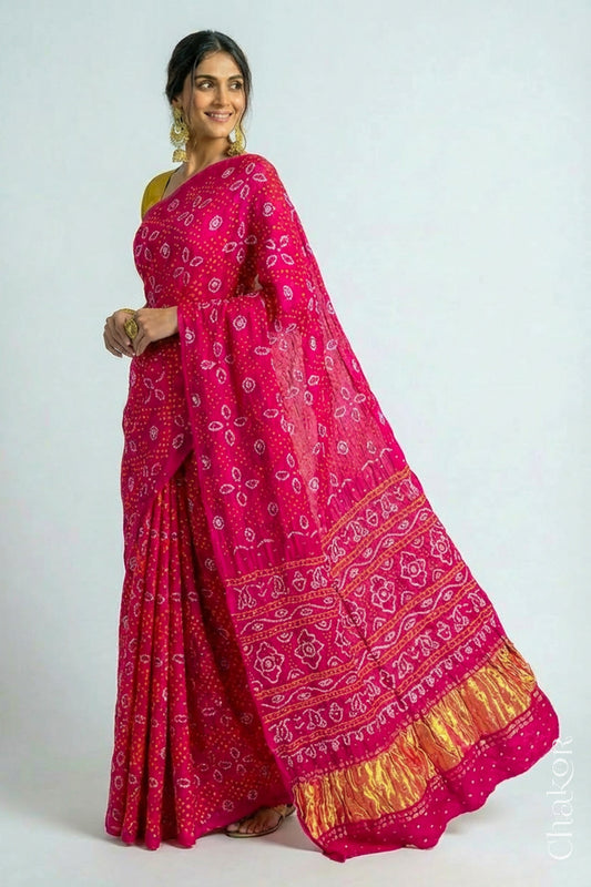 Woman wearing Handcrafted Rani pink Bandhani Gaji Silk Saree with traditional bandhej patterns and sequins embroidery.