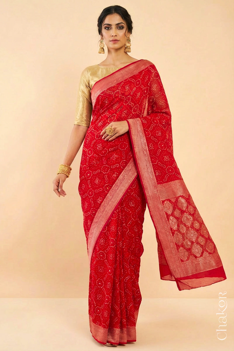 Woman wearing Handcrafted Red Bandhani Banarasi Georgette Saree in pure silk featuring zari weaving and Kutch Bandhej with mirror embroidery, Perfect for wedding and occasions.