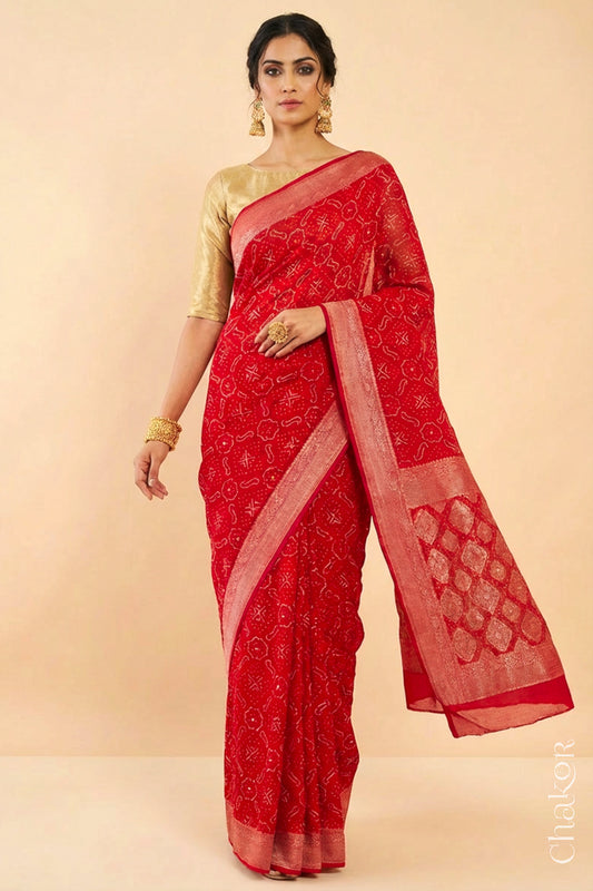 Woman wearing Handcrafted Red Bandhani Banarasi Georgette Saree in pure silk featuring zari weaving and Kutch Bandhej with mirror embroidery, Perfect for wedding and occasions.