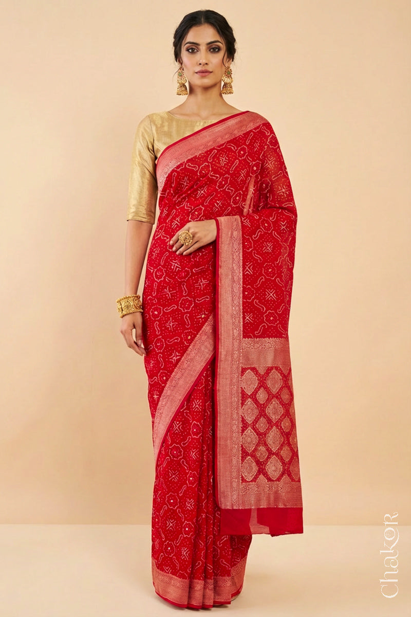 Woman wearing Handcrafted Red Bandhani Banarasi Georgette Saree in pure silk featuring zari weaving and Kutch Bandhej with mirror embroidery, Perfect for wedding and occasions.
