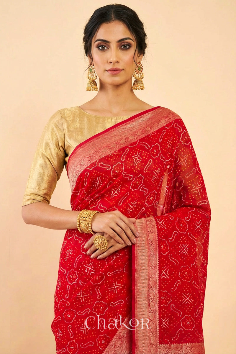 Woman wearing Handcrafted Red Bandhani Banarasi Georgette Saree in pure silk featuring zari weaving and Kutch Bandhej with mirror embroidery, Perfect for wedding and occasions.