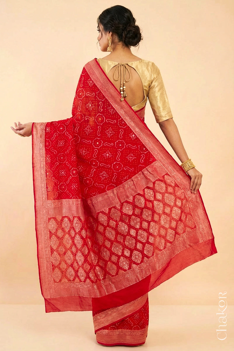 Woman wearing Handcrafted Red Bandhani Banarasi Georgette Saree in pure silk featuring zari weaving and Kutch Bandhej with mirror embroidery, Perfect for wedding and occasions.