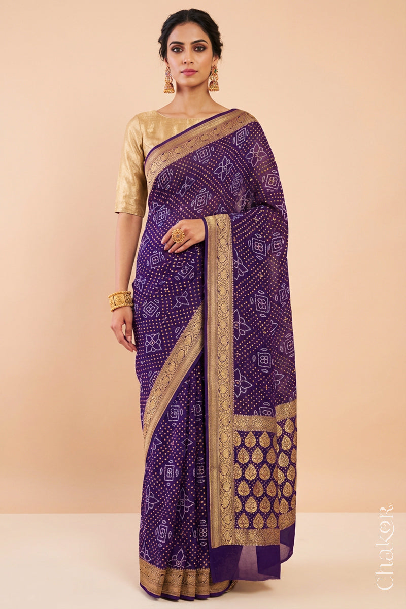 Woman wearing Handcrafted Purple Bandhani Banarasi Georgette Silk Saree featuring zari weaving and Kutch Bandhej with mirror embroidery.