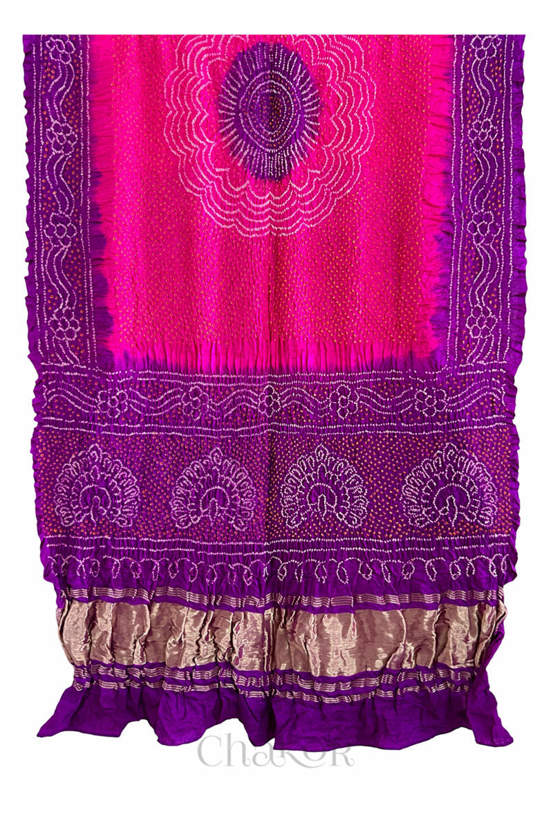 Pink and purple Bandhani gaji silk dupatta laid flat showing peacock motif pallu and contrast border.