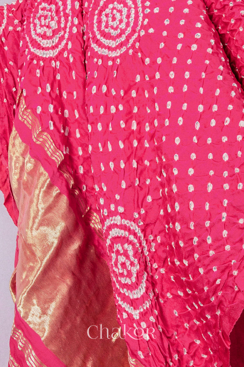 Coral Bandhani gaji silk dupatta laid flat showing circular motifs and lagdi patto pallu.