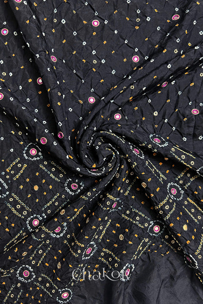 Black mulberry silk Bandhani (Rai Bandhej) fabric with white and yellow tie-dyed motifs, pink with zari mirror and sequin embellishment, arranged in a swirling design  – CHAKOR.