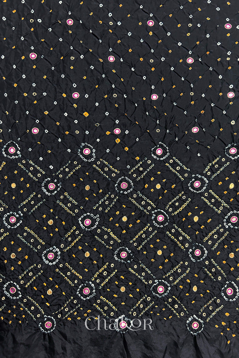 Black mulberry silk Bandhani (Rai Bandhej) fabric showing full layout with white and yellow tie-dye butis, geometric bandhej pattern, and pink with zari mirror & sequins embroidery – CHAKOR.