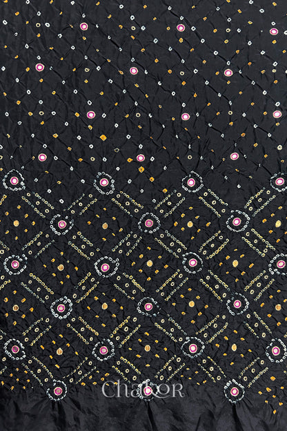 Black mulberry silk Bandhani (Rai Bandhej) fabric showing full layout with white and yellow tie-dye butis, geometric bandhej pattern, and pink with zari mirror & sequins embroidery – CHAKOR.