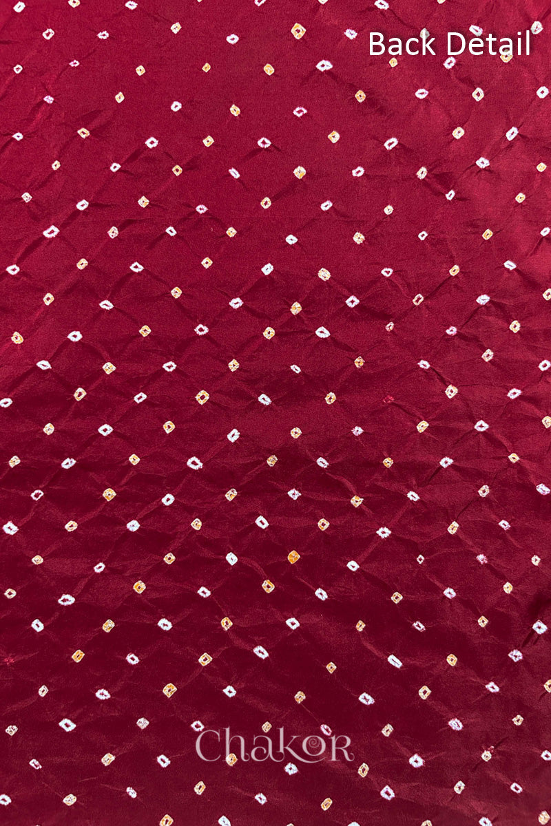 Back detail of Deep Red mulberry silk Bandhani (Rai Bandhej) fabric with white and yellow tie-dye butis in an all-over pattern – CHAKOR.

