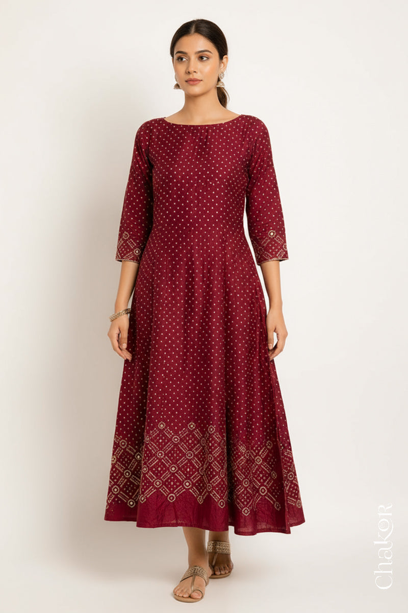 Deep Red mulberry silk Bandhani (Rai Bandhej) dress stitched from the fabric, featuring all-over white and yellow butis and a geometric mirror-work hem border – CHAKOR
