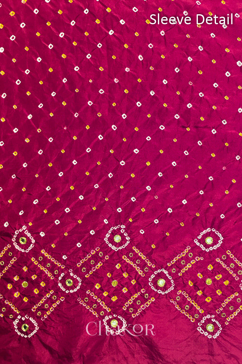 Sleeve detail of Rani Pink mulberry silk Bandhani (Rai Bandhej) fabric with white and yellow butis, geometric bandhej borders and golden zari mirror embroidery – CHAKOR.