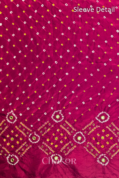 Sleeve detail of Rani Pink mulberry silk Bandhani (Rai Bandhej) fabric with white and yellow butis, geometric bandhej borders and golden zari mirror embroidery – CHAKOR.