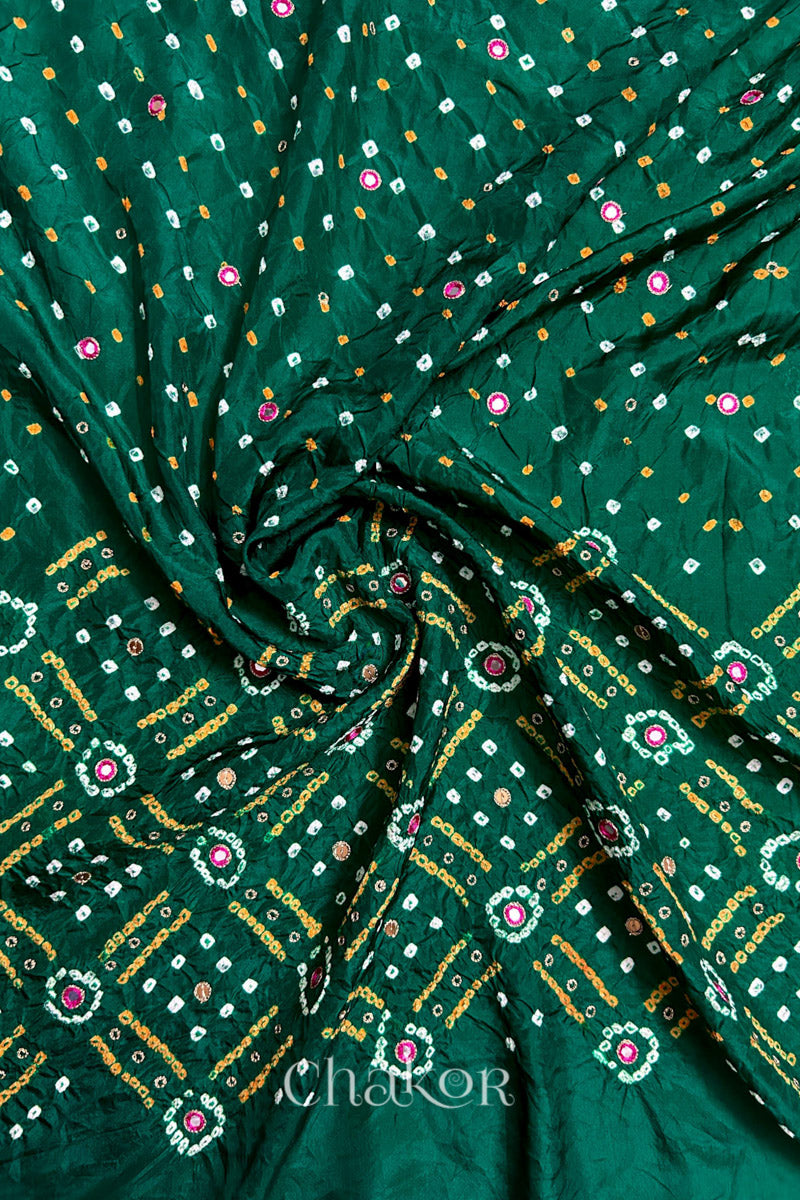 Green mulberry silk Bandhani (Rai Bandhej) fabric with white and yellow tie-dyed motifs, pink mirror and sequin embellishment, arranged in a swirling design  – CHAKOR.