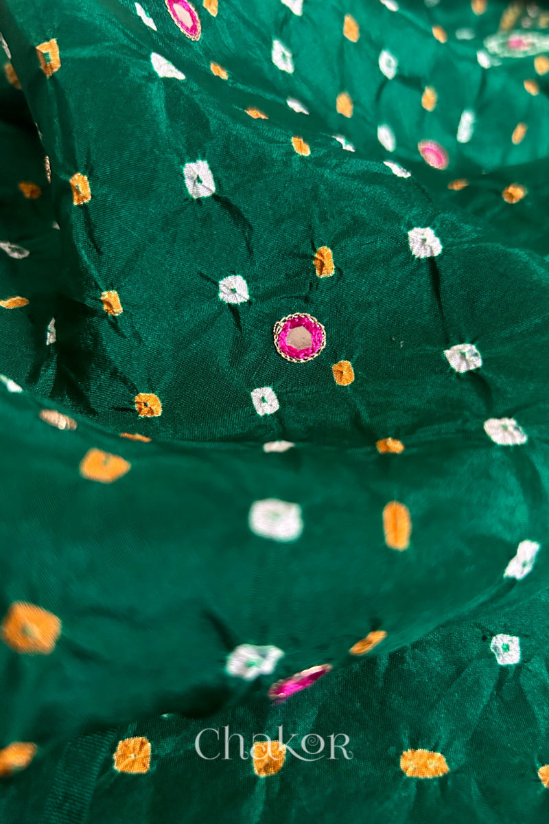 Close-up of Green mulberry silk Bandhani (Rai Bandhej) fabric with white and mustard tie-dyed butis and a pink embroidered mirror motif – CHAKOR.