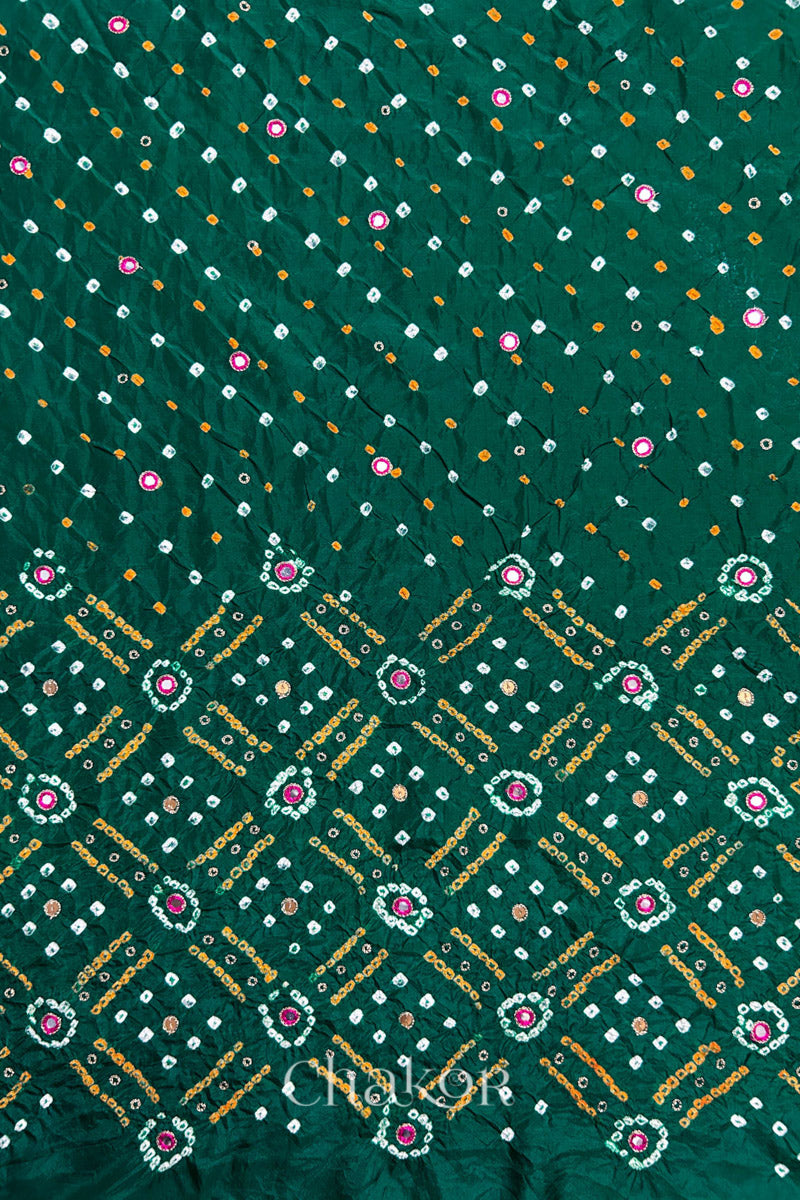 Green mulberry silk Bandhani (Rai Bandhej) fabric showing full layout with white and mustard tie-dye butis, geometric bandhej grids, and pink mirror motifs – CHAKOR.
