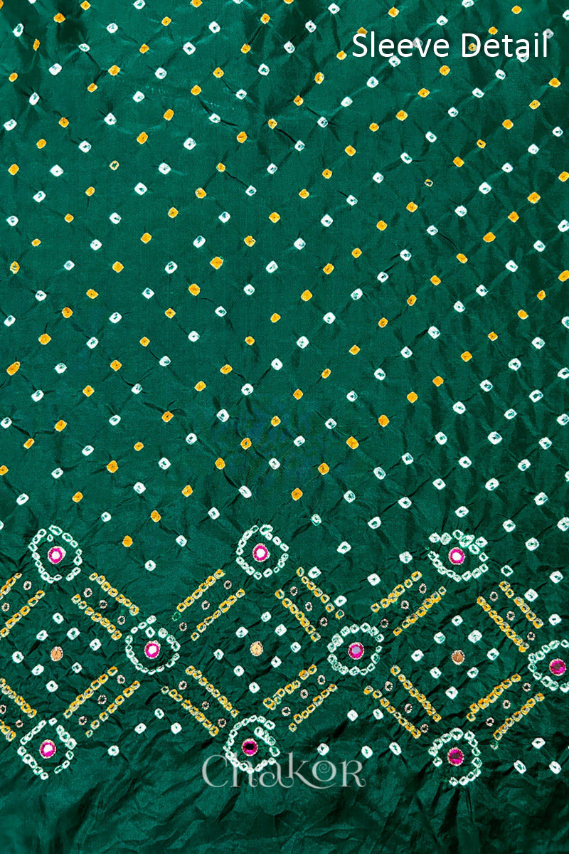Sleeve detail of Green mulberry silk Bandhani (Rai Bandhej) fabric with white and mustard butis, geometric bandhej borders and pink mirror motifs – CHAKOR.