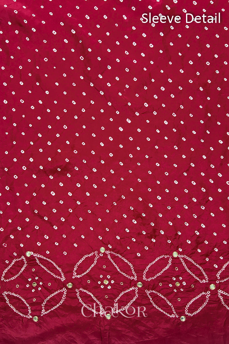 Sleeve detail of Deep Red mulberry silk Bandhani (Rai Bandhej) fabric with white dots, floral bandhej borders and golden zari mirror embroidery – CHAKOR.
