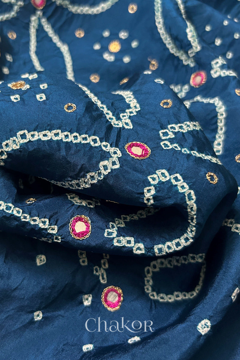 Close-up of Indigo Blue mulberry silk Bandhani (Rai Bandhej) fabric with white tie-dye motifs, zari embroidered pink mirror work and sequin detailing – CHAKOR.
