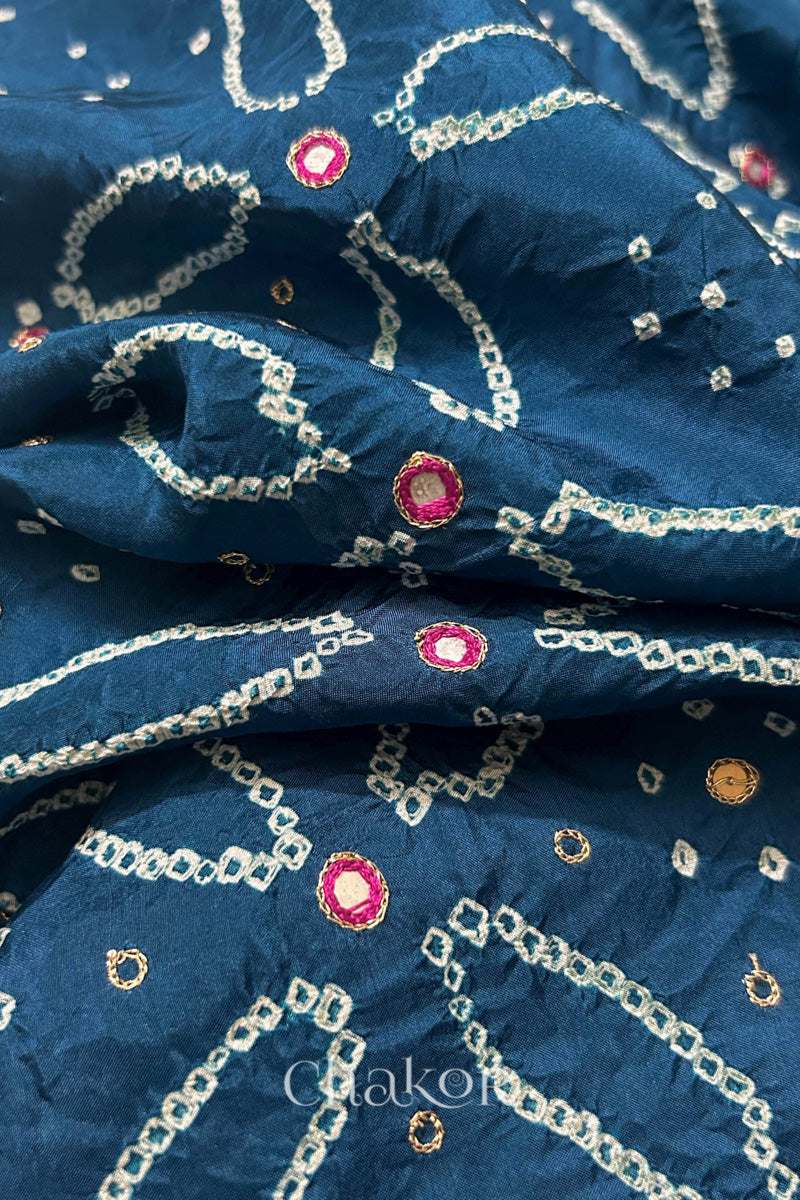 Close-up of Indigo Blue mulberry silk Bandhani (Rai Bandhej) fabric with white tie-dye motifs, zari embroidered pink mirror work and sequin detailing – CHAKOR.
